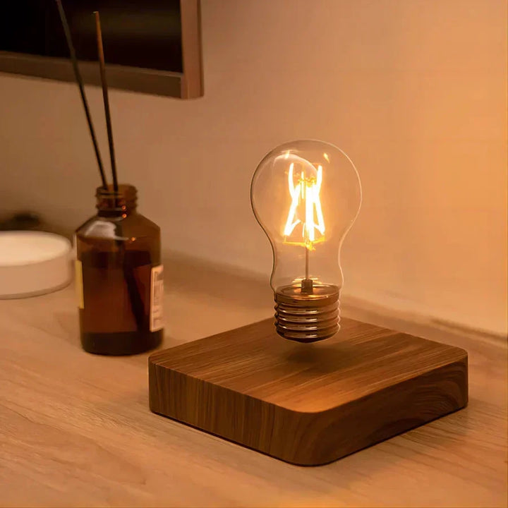 Unique floating light bulb lamp with a rich walnut wood base. Levitating design for a captivating modern lighting accent.