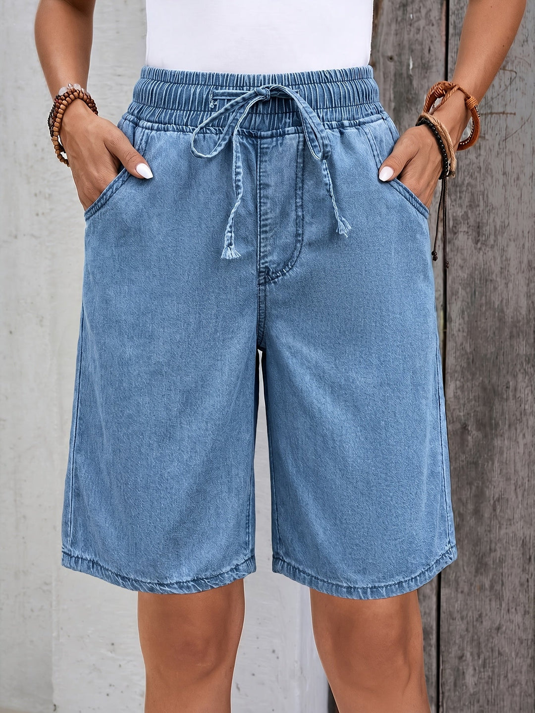 Light blue women's bermuda jean shorts with comfortable elastic drawstring waist, perfect for casual summer wear.