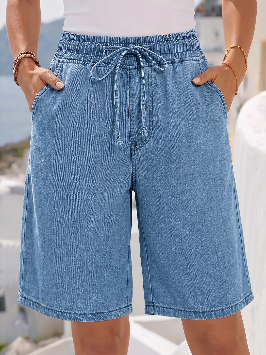 Relaxed fit wide-leg light blue women's bermuda shorts, featuring an elastic drawstring waist for everyday comfort.