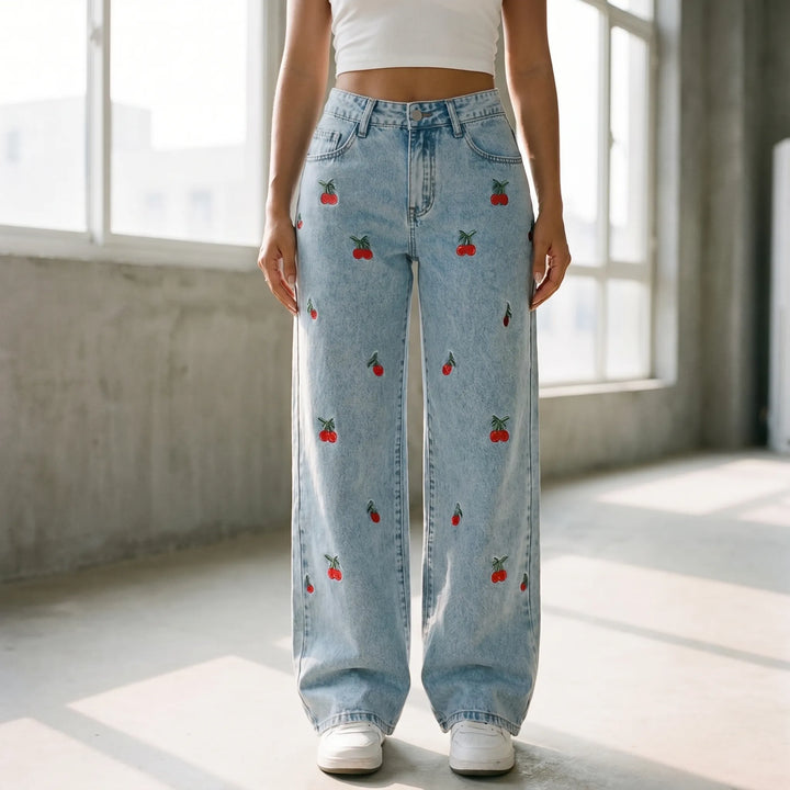 Light wash women's high-waisted wide-leg jeans with delicate cherry embroidery, perfect for casual summer streetwear.