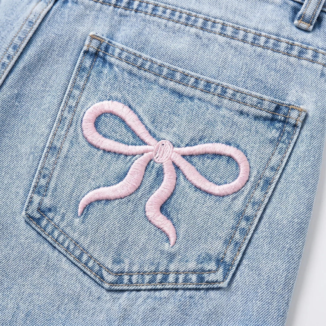 Women's light wash wide-leg jeans with charming cherry embroidery. High-waisted denim for a flattering, casual look.