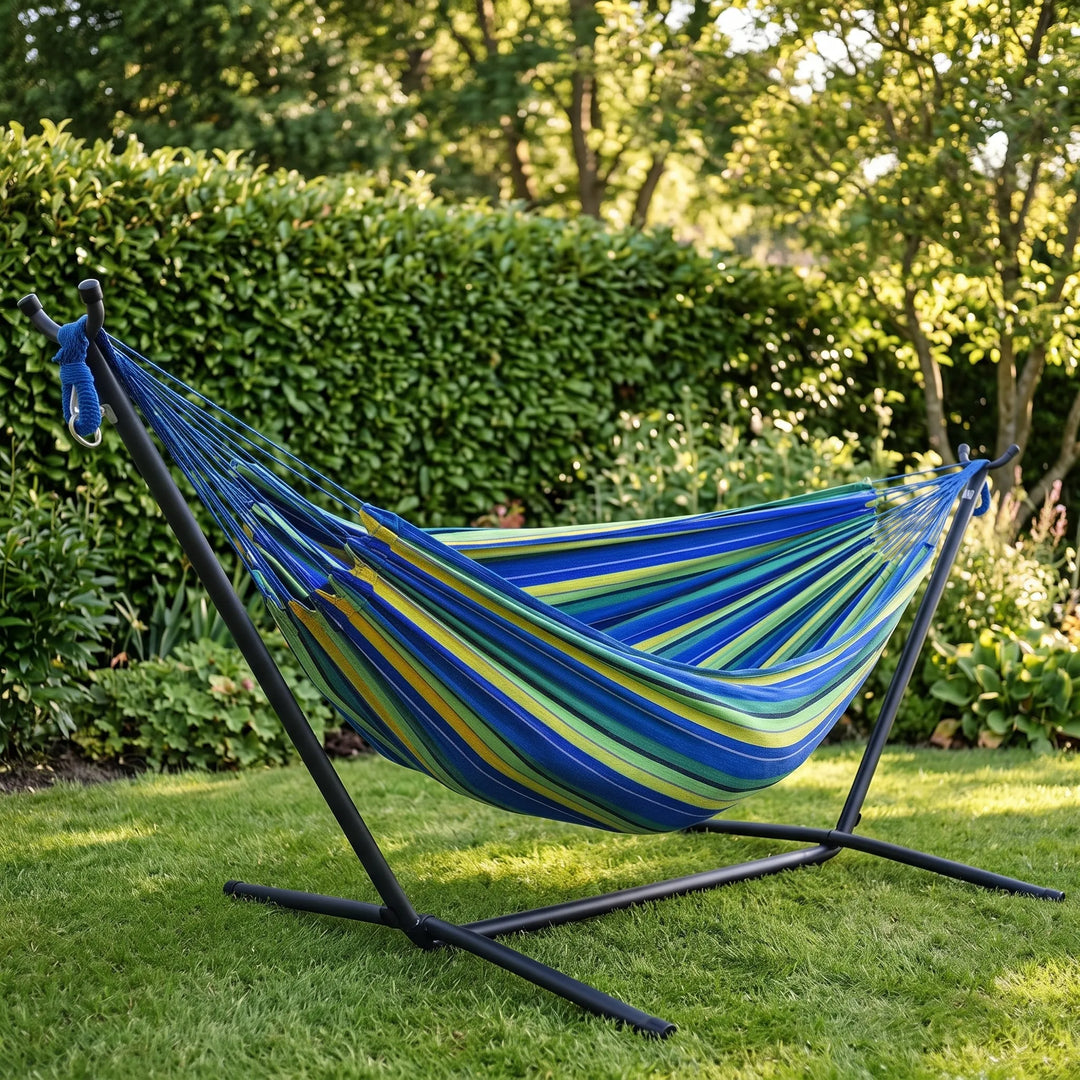 Striped single-person canvas portable hammock for ultimate outdoor relaxation in a garden or campsite.