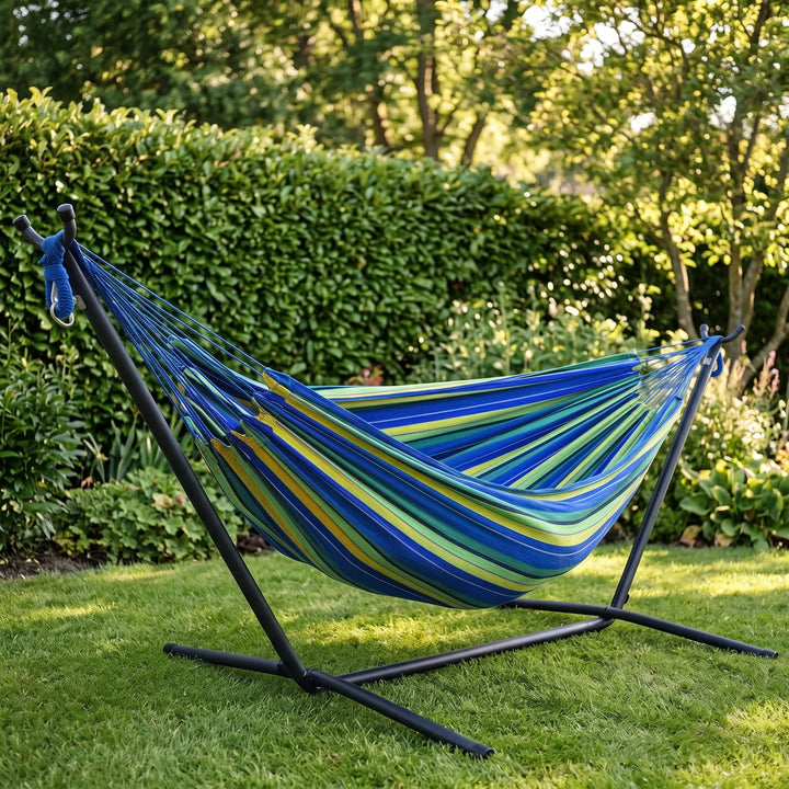 Striped single-person canvas portable hammock for ultimate outdoor relaxation in a garden or campsite.