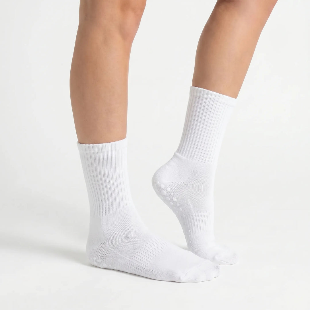 Close-up of lilac women's grippy athletic crew socks, showcasing non-slip sole for safe studio workouts.