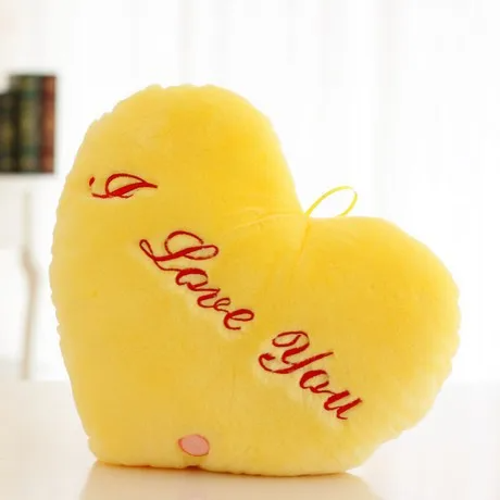 Stack of luminous star and heart plush pillows, soft kids' decor with built-in night light.