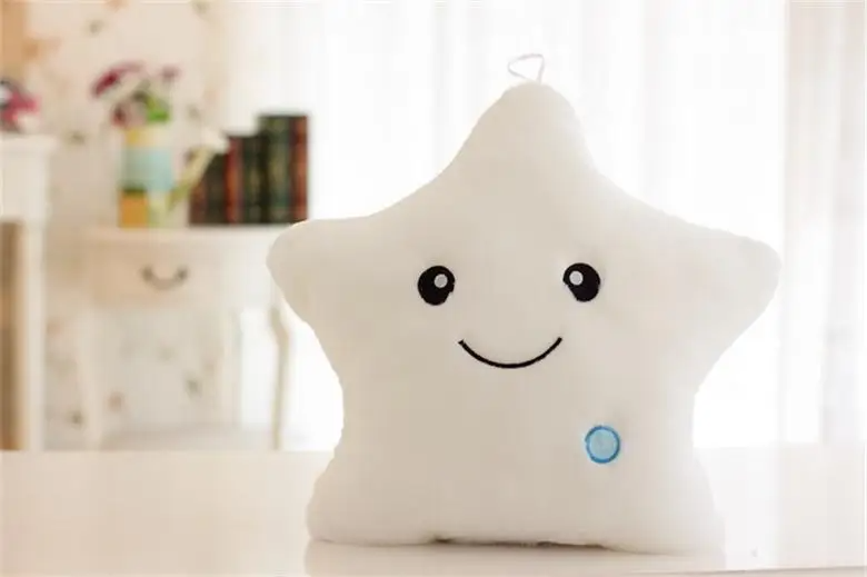 Close-up of a luminous star plush pillow, showing soft fabric and gentle glow for kids.