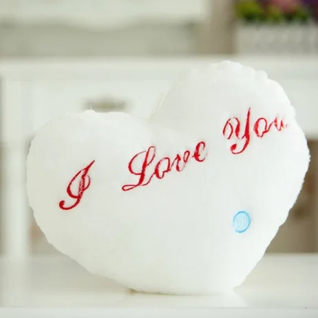 Blue luminous star plush pillow, glowing comfort item for children's bedroom, soft texture.
