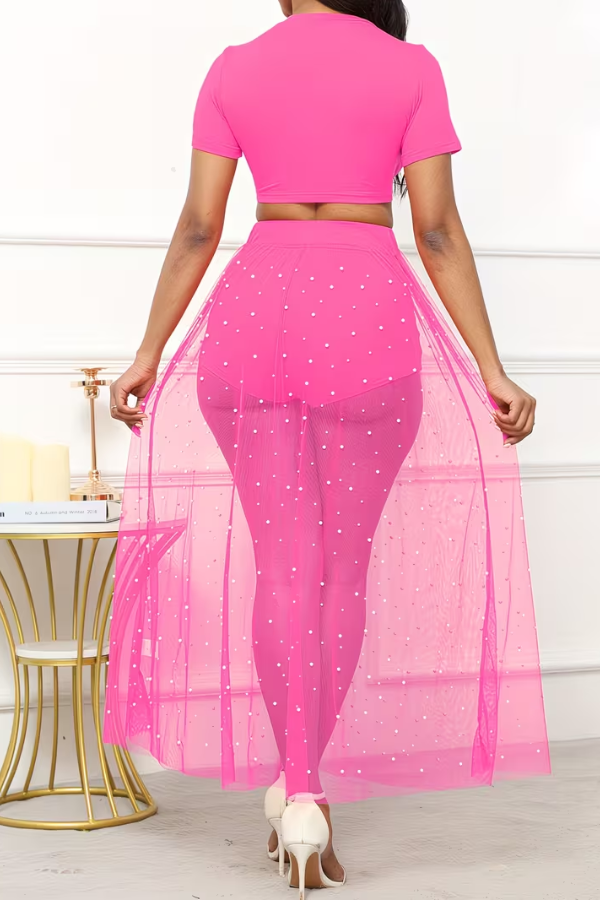 Glamorous women's three-piece beach ensemble: crop top, sheer skirt with pearls, and shorts for stunning summer style.