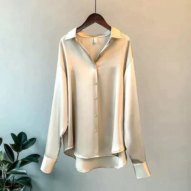 Luxurious women's relaxed fit button-up shirt in classic style. Elegant long sleeve blouse for office or casual chic.