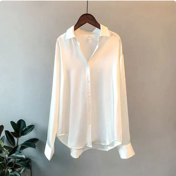 Close-up of elegant women's button-up shirt. Relaxed fit long sleeve blouse, ideal for office wear and casual style.