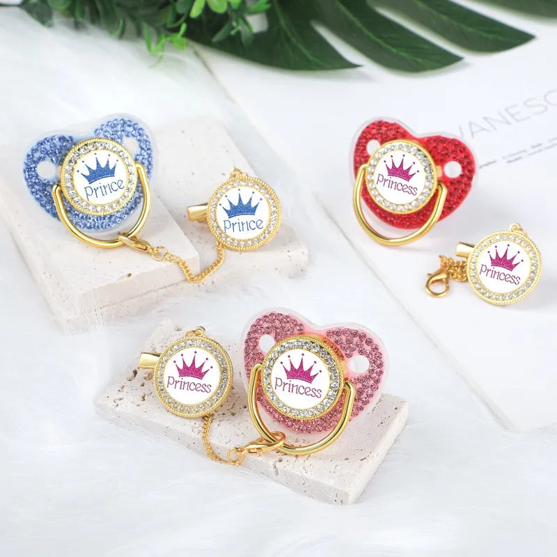 Designer baby pacifier & clip featuring a prominent gold crown, great baby gift.
