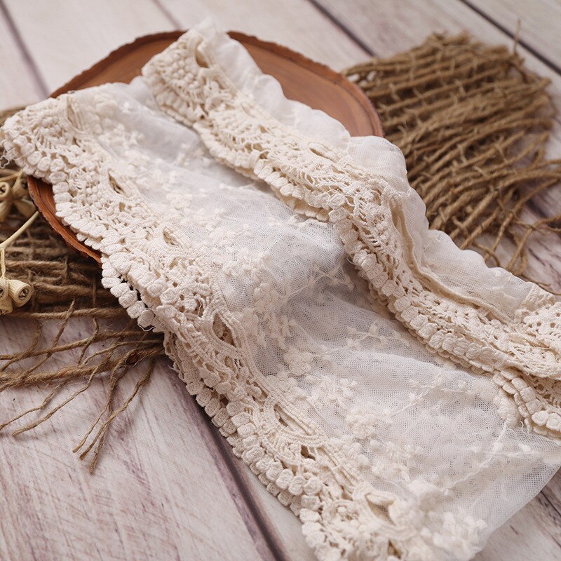 Newborn wrap swaddle blanket with mesh lace edging, essential for infant comfort in nursery.