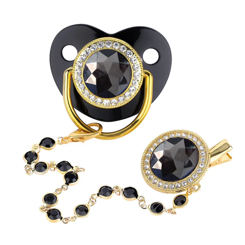 Front view of the rhinestone baby pacifier, gold clip, and cover for feeding
