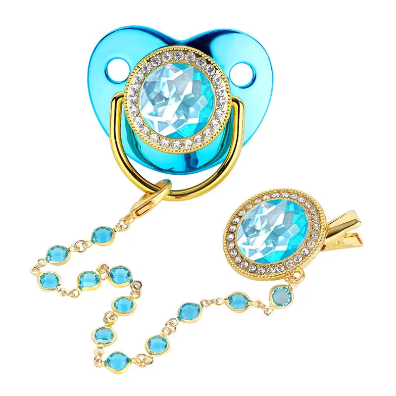 Close-up of golden rhinestone pacifier & clip set, baby feeding, infant accessories
