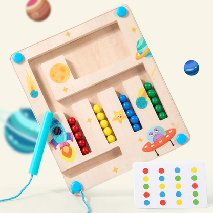 Hand guiding magnetic wand through a wooden color maze game, focusing on matching and sorting colors for kids