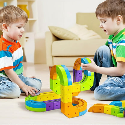 STEM toy: Child building a magnetic train track with cube blocks, educational fun