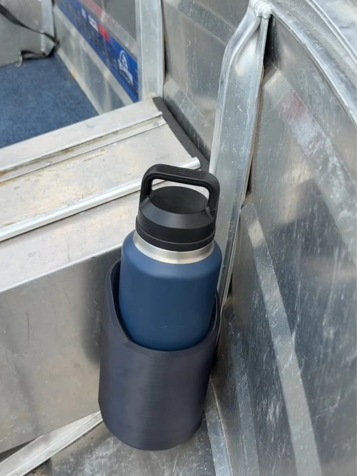Heavy-duty magnetic beverage holder for industrial workshop & garage. Securely mounts bottles, keeping hands free.