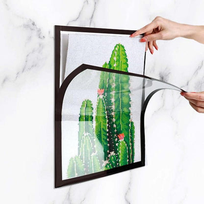 Magnetic home art display frame holding a child's colorful painting, easy to change artwork