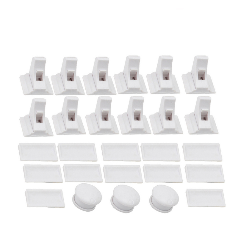Set of magnetic childproof cabinet locks with installation template, securing drawers and cabinets.