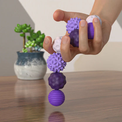 Hand holding magnetic silicone sensory toy, demonstrating its flexible and tactile nature.