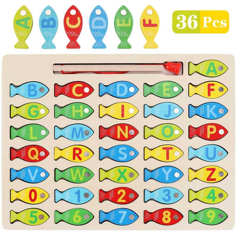 Child concentrating on magnetic fishing rod catching wooden letter fish, learning game for kids