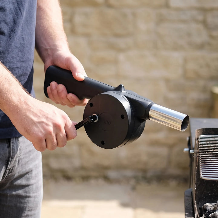 Manual BBQ fan, hand-crank blower for outdoor grilling, charcoal starting, and campfires.