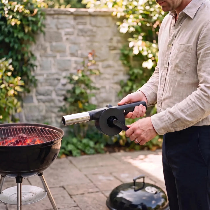 Portable manual BBQ fan, hand-cranked for easy charcoal lighting, grilling, and campfire starting.