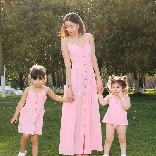 Matching family strapless button dresses and baby rompers, ideal for summer beach wear