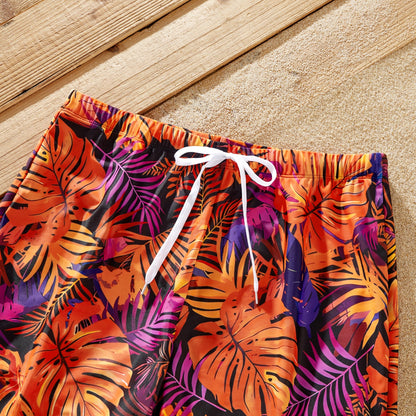 Close-up of vibrant floral print on matching family tropical swimsuits.
