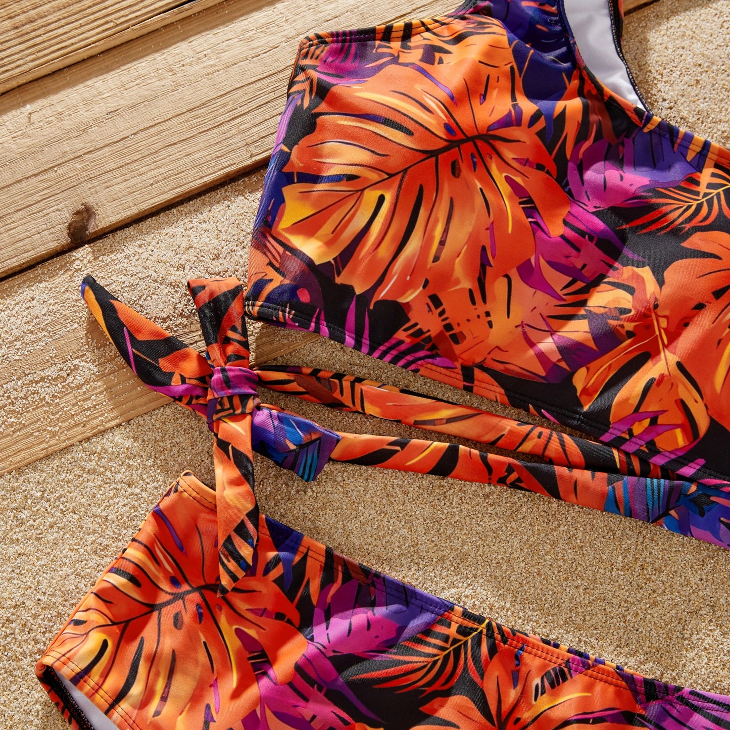 Family wearing floral matching swimwear enjoying a tropical boat trip.