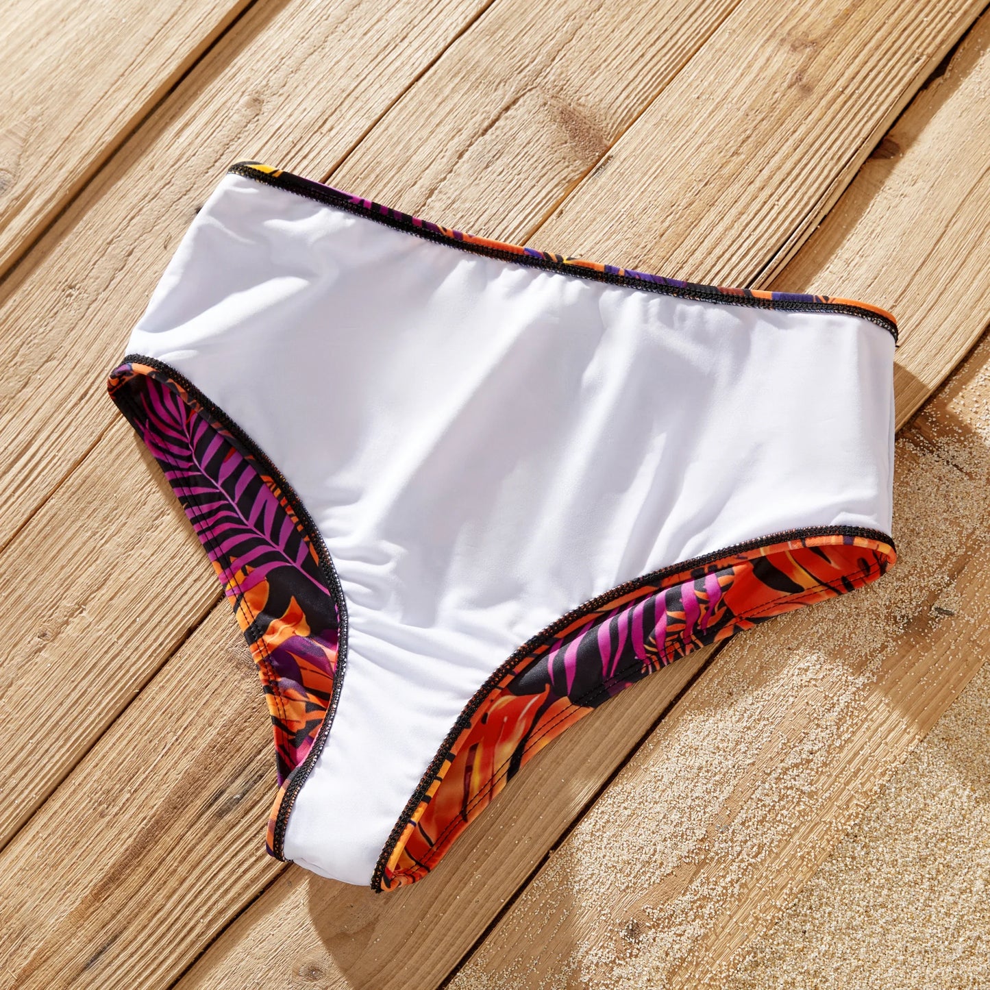 Father & son matching floral swim trunks for summer beach adventures.