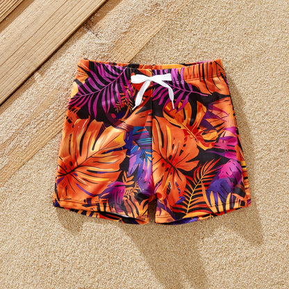 Boy's floral swim shorts. Kids' matching swimwear, perfect for beach adventures.