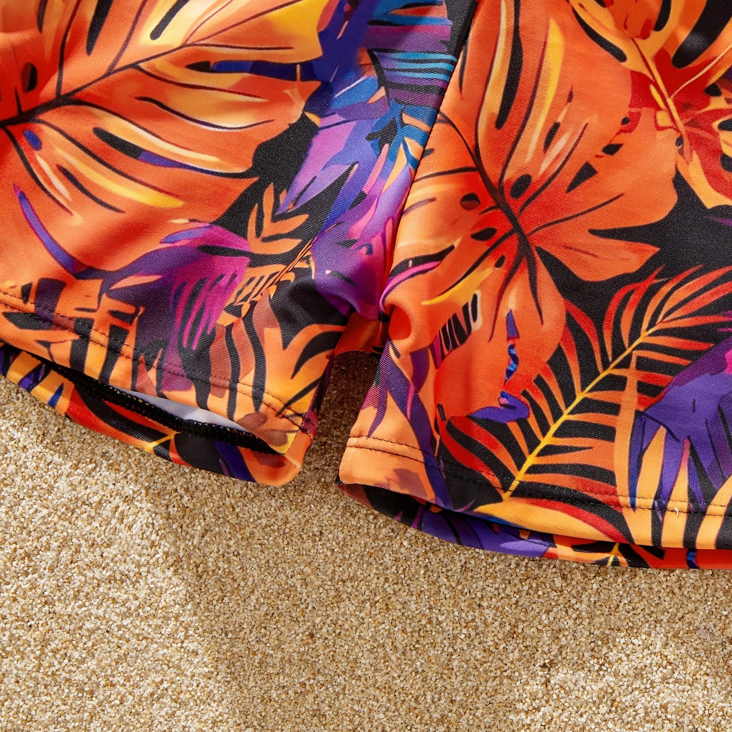 Coordinated floral print swimsuits for couples. Perfect for a tropical getaway.