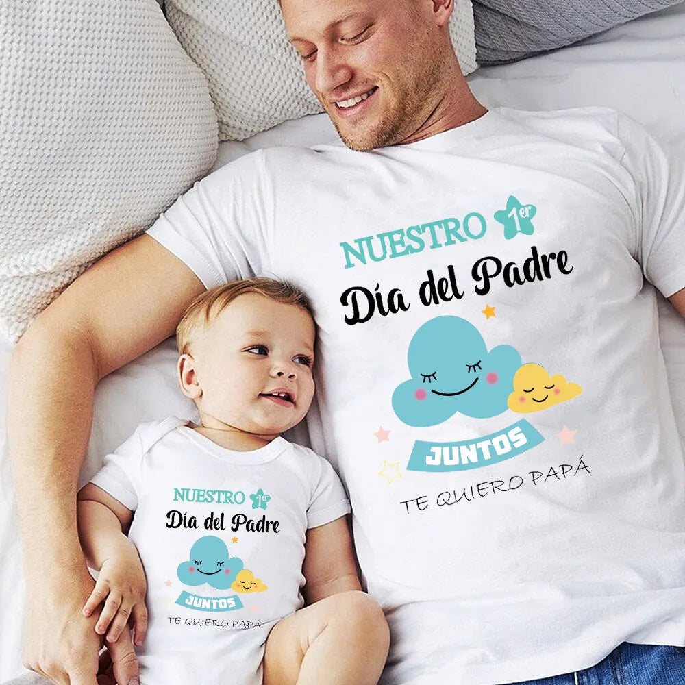 Close-up of a 'First Father's Day' graphic on a men's t-shirt and infant romper, family matching set.