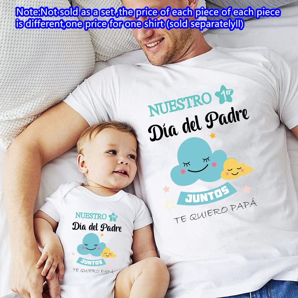 Full shot of father and infant son in identical 'My First Father's Day' matching t-shirt and romper.