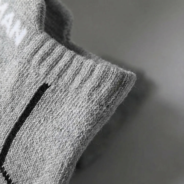 Close-up of men's low-cut athletic socks (6-pack). Designed for breathability & comfort during sports.