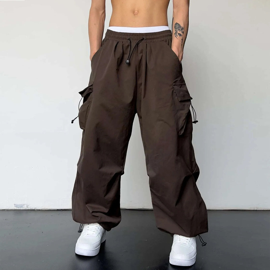 Men's comfortable baggy parachute cargo pants. Loose fit utility pants for street style & hip hop fashion.