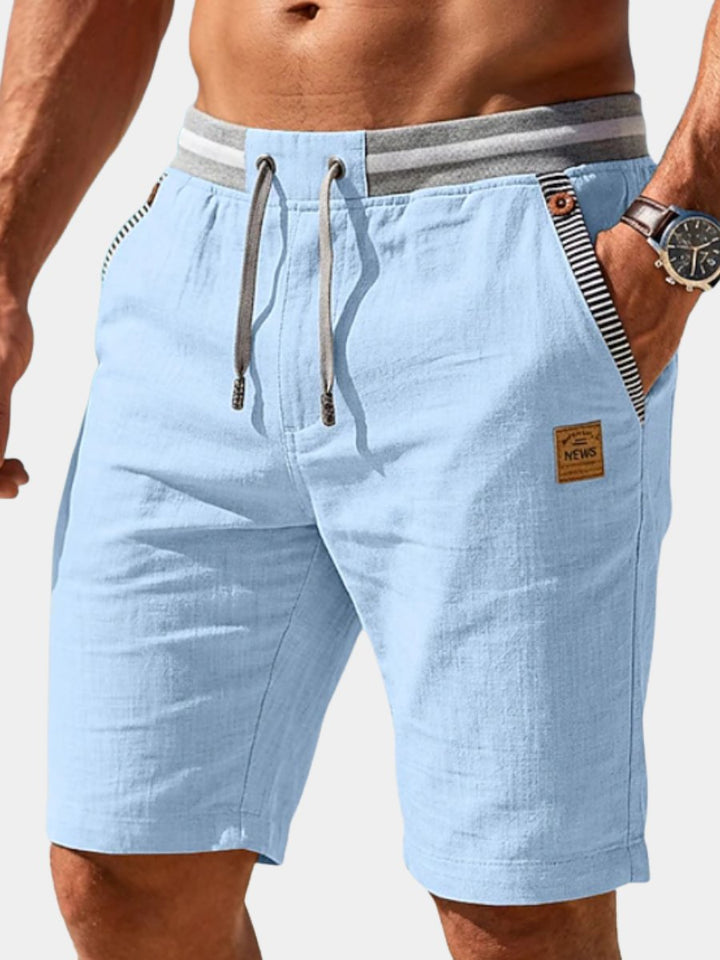 Men's blue drawstring summer shorts, relaxed fit for casual everyday wear and warm weather comfort.