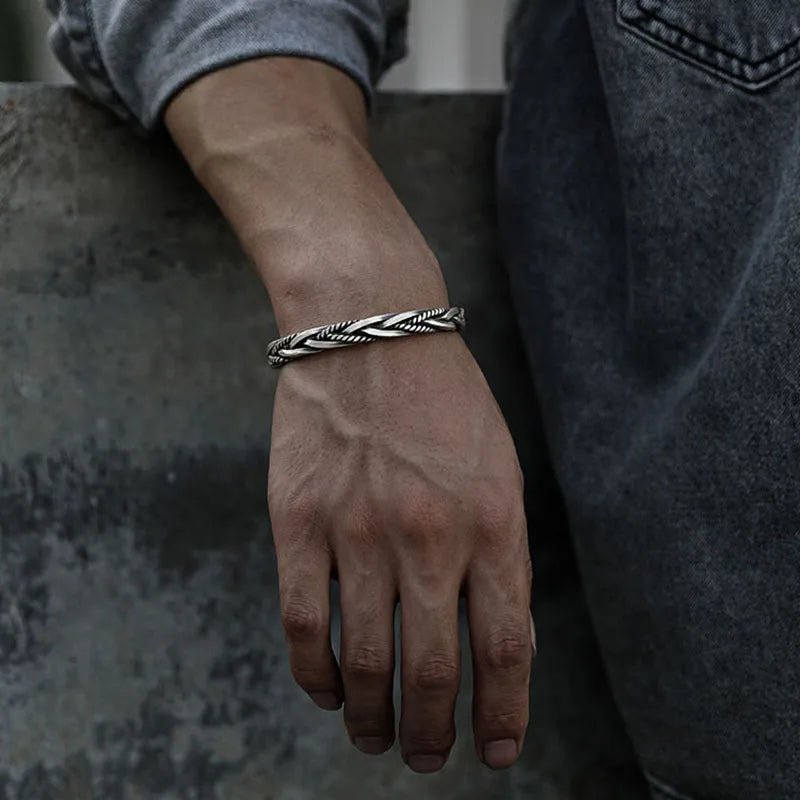 Handcrafted braided sterling silver men's bracelet, an adjustable statement piece for men's fashion.