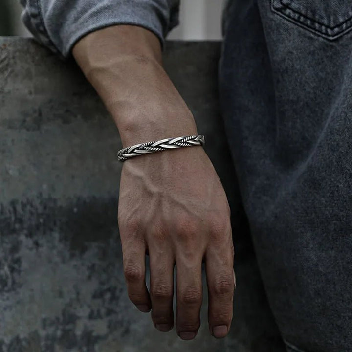 Handcrafted braided sterling silver men's bracelet, an adjustable statement piece for men's fashion.