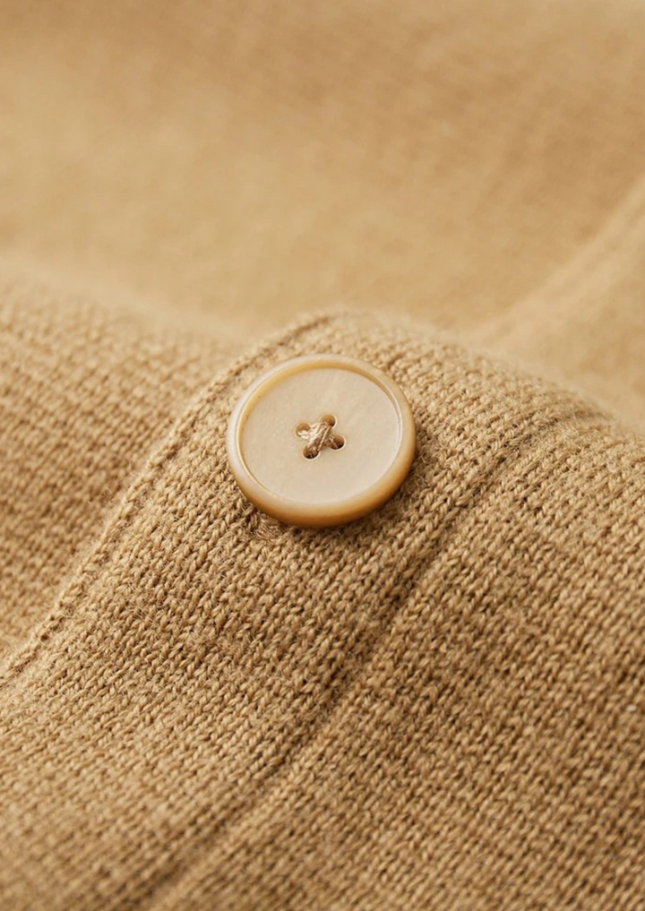 Comfortable men's button-up cardigan with patch pockets, a modern and sophisticated layering piece.