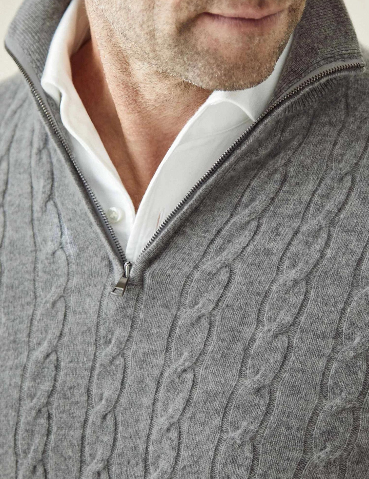 Men's cable-knit quarter-zip sweater on model, highlighting smart casual fit.
