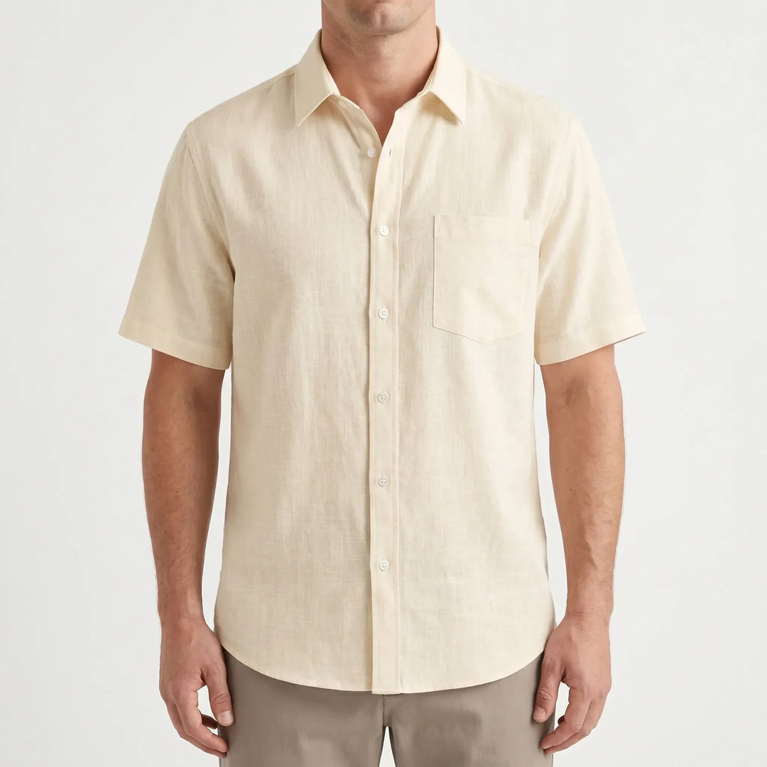 Relaxed fit men's button-up shirt with short sleeves, designed for warm weather comfort & casual style.