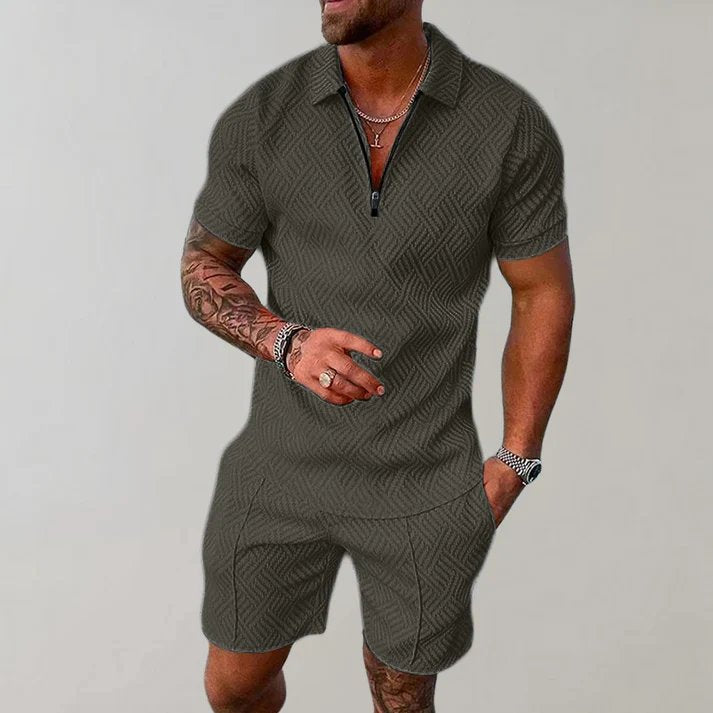 Man wearing a relaxed fit men's zip polo short set in grey, perfect for beach walks or casual outings.