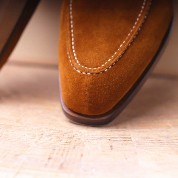 Close-up of men's classic leather Oxford dress shoes, highlighting fine craftsmanship & durable premium material.