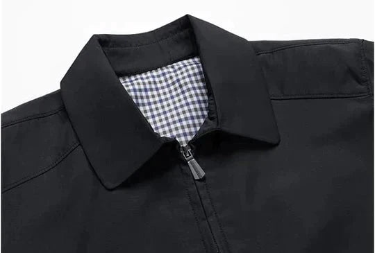 Front view of a men's zip-up jacket with a sleek design and subtle checked lining, great for layered outfits.