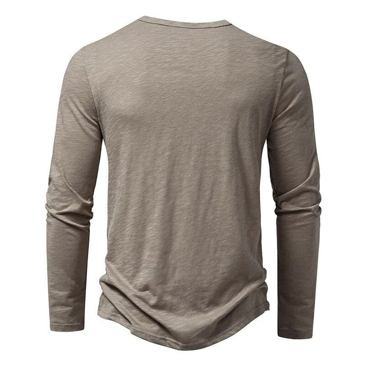 White men's classic slim fit Henley shirt with button placket, an essential long sleeve top.