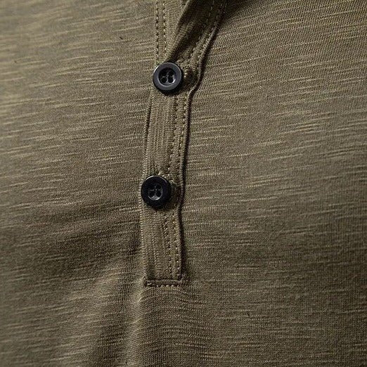 Close-up of the button placket on an army green men's slim fit long sleeve Henley shirt.
