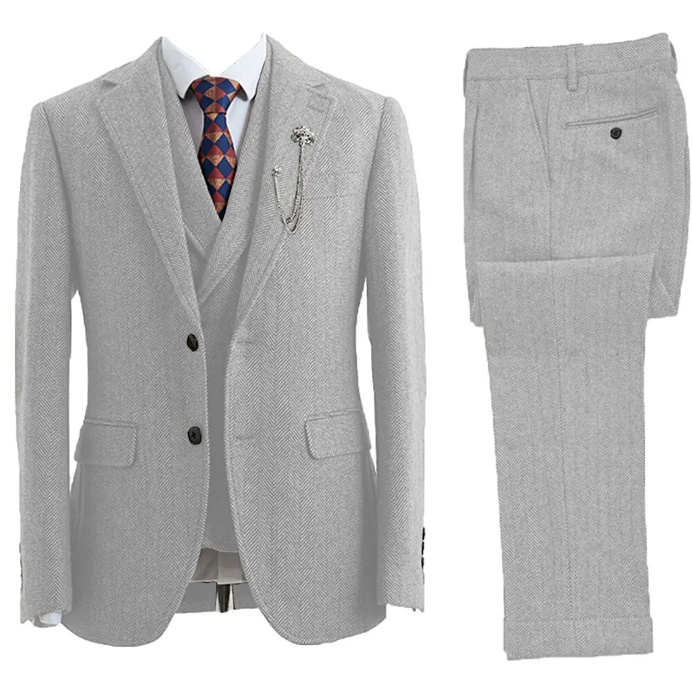 Stylish man wearing a tailored fit 3-piece herringbone suit, exuding classic elegance for formal occasions.