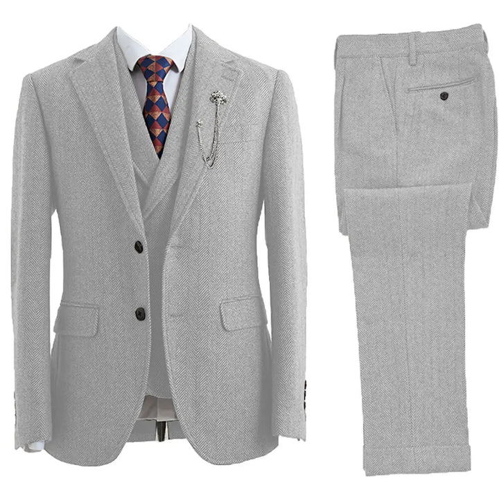 Stylish man wearing a tailored fit 3-piece herringbone suit, exuding classic elegance for formal occasions.